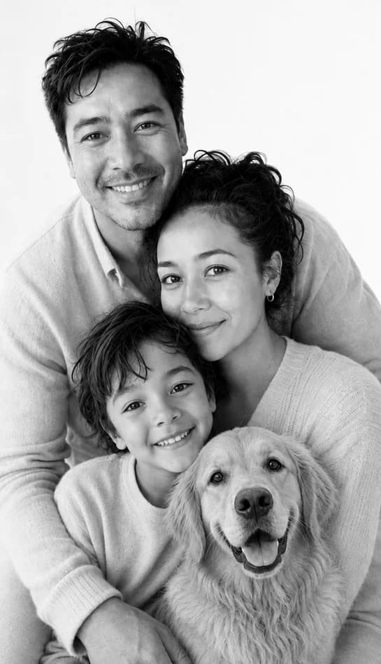 Black-and-white Stacked Love portrait of the same parents, son, and golden retriever against a white backdrop